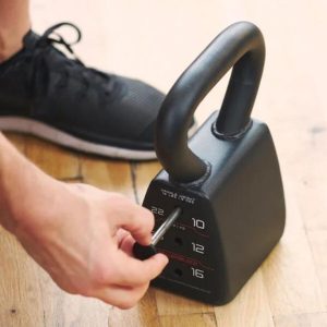 Someone adjusting a PowerBlock Pro Adjustable Kettlebell