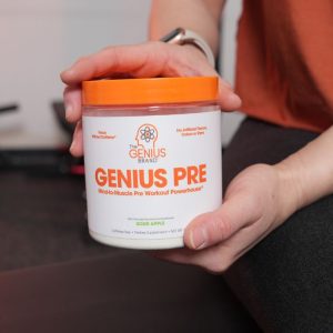 a person holding a tub of the genius brand pre workout