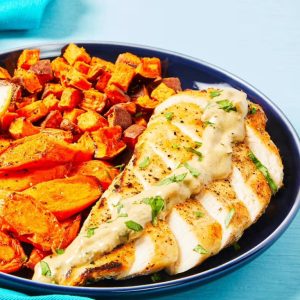 a prepared meal with chicken breast, cubed baked sweet potatoes, and baked carrots from an EveryPlate meal kit