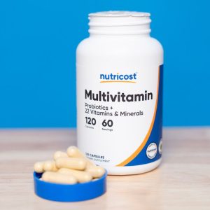 bottle of nutricost multivitamin next to capsules in lid