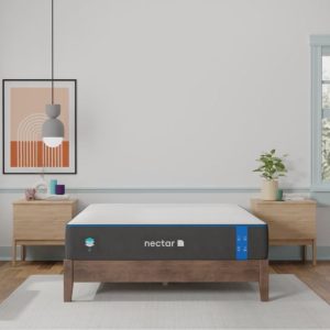 A mattress on a wooden bed frame with a modern, minimalist bedroom setting.