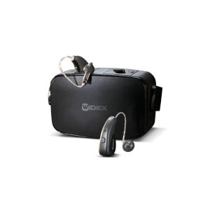 A Widex hearing aid next to its black charging case. The hearing aid is black with a metallic finish and a thin wire connecting to a small earpiece.