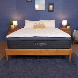 Helix Midnight Luxe mattress on a wooden bed frame, designed for pressure relief