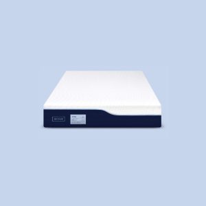 Modern mattress with white top and dark blue sides, displayed against a light blue background