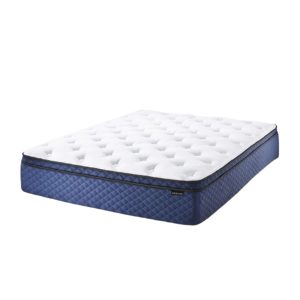 Comfortable hybrid mattress with a quilted white top and blue diamond-patterned sides, placed in a bedroom