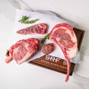 a few cuts of beef on a cutting board displayed from the meat delivery box company snake river farms