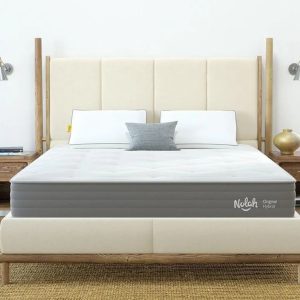 Nolah Original Hybrid mattress on a cream-colored bed frame in a bright, serene bedroom.