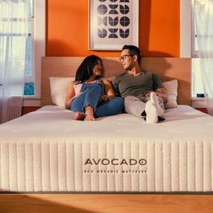 avocado eco green organic mattress with a couple sitting on top