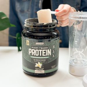 Tester scooping out Onnit Plant Based Protein of the package