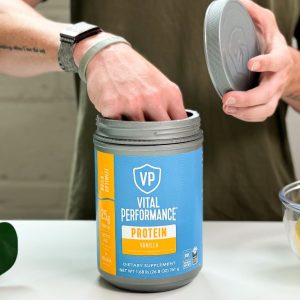 Tester scooping Vital Performance Protein Powder out of the package