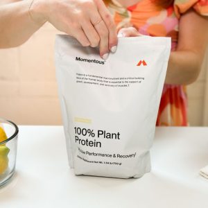 Tester opening a package of Momentous 100% Plant Protein