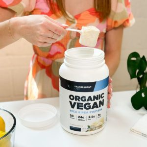 Tester scooping out Transparent Labs Organic Vegan Rice and Pea Protein Powder from the container