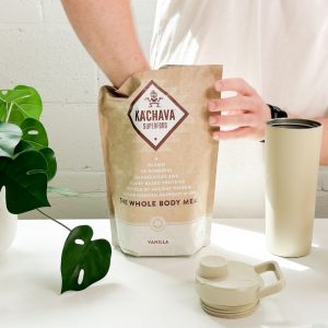 Tester scooping Ka’Chava vegan protein powder.