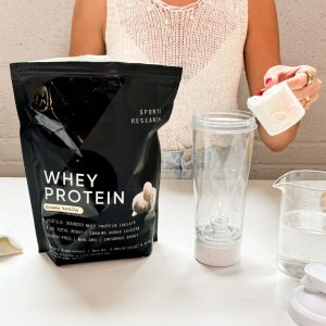 Tester with a scoop of Sports Research Whey Protein