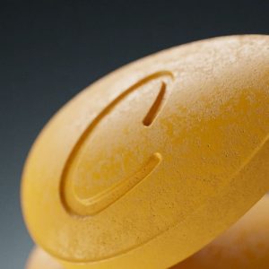 Close-up of Roman Cialis yellow pill for ED treatment