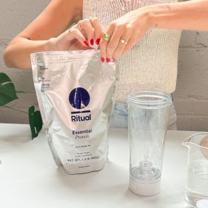 person opening silver ritual essential protein daily shake bag